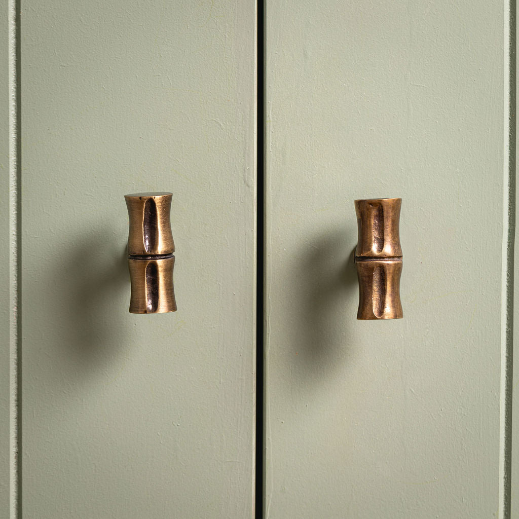 Bamboo T-Bar Knob, Aged Brass on a cupboard