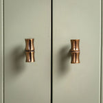 Bamboo T-Bar Knob, Aged Brass on a cupboard