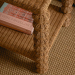 Wicker chair with a book on top on a textured surface
