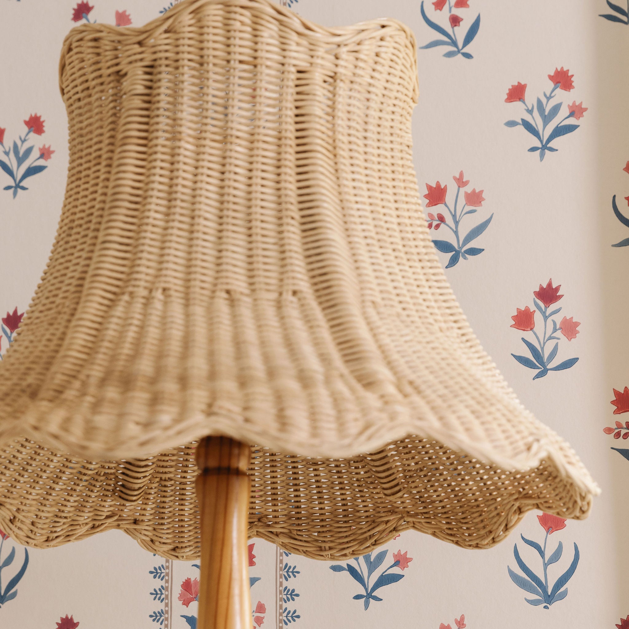 Wicker lampshade on a floral wallpaper background