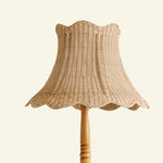 Cecelia wicker lampshade on a wooden stand against a beige background