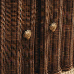 Close-up of woven brown material with butterfly-shaped metal decorations.