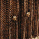 Close-up of woven brown material with butterfly-shaped metal decorations.