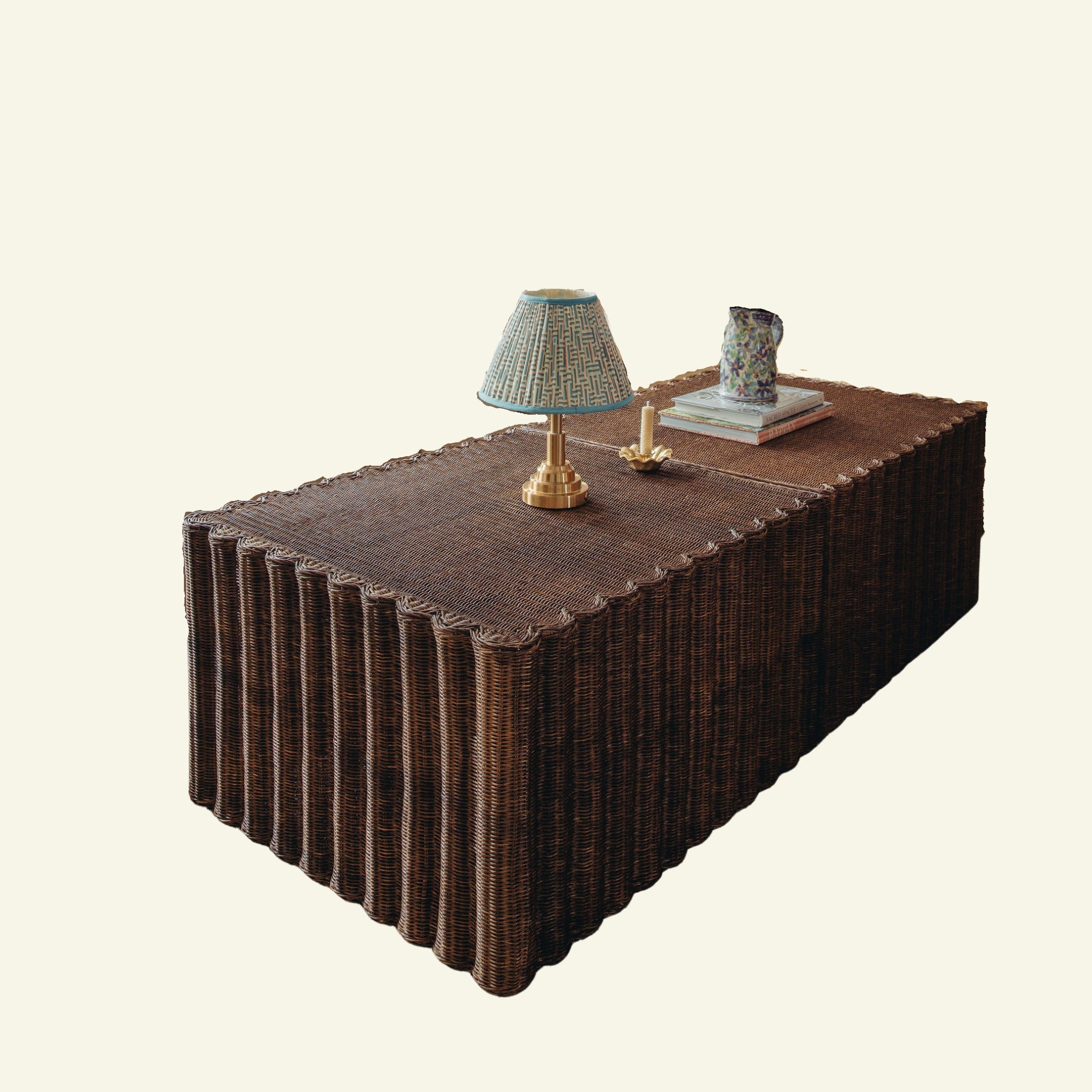 Daisy wicker coffee table with decorative items on a beige background