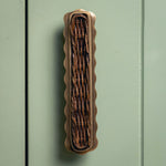 Delilah Handle Teak, Aged Brass on green