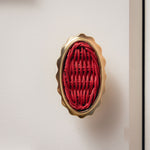 Delilah Oval Knob Red, Lacquered Brass close up
