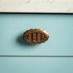 Delilah Oval Knob Teak, Aged Brass on blue