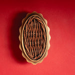 Delilah Oval Knob Teak, Aged Brass on red
