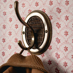 Decorative wall hook with a patterned background