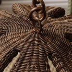 Close-up of a woven wicker pendant with a decorative handle.