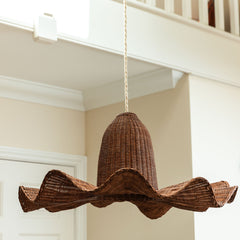 Woven brown pendant light hanging from a ceiling