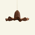 Brown wicker pendant light on a beige background