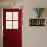 Luna-wall-light-large-light-blue-on-a-wall-with-painting