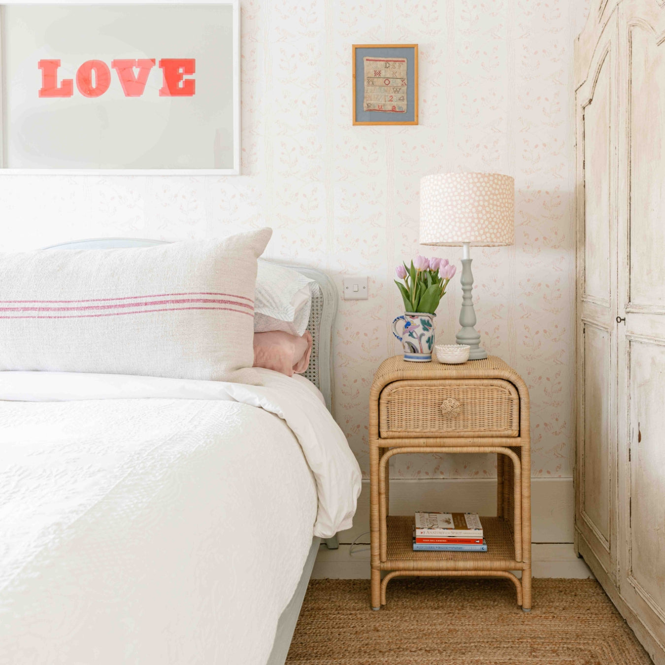 Bedroom with a bed, Phoenix nightstand, and decor elements.