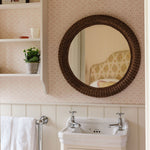 Polly-rattan-round-mirror-in-the-bathroom