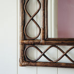 RETRO-RATTAN-MIRROR-TEAK-ON-A-WALL-CLOSE-UP-IMAGE