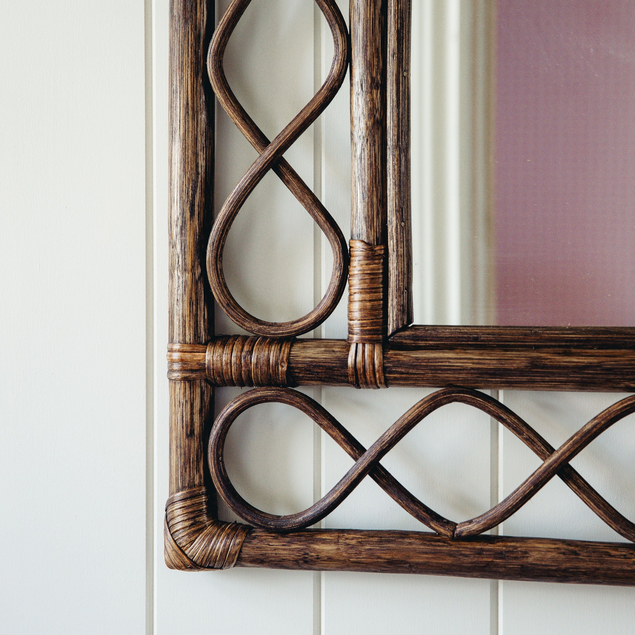 RETRO-RATTAN-MIRROR-TEAK-ON-A-WALL-CLOSE-UP-IMAGE