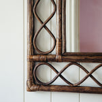 RETRO-RATTAN-MIRROR-TEAK-ON-A-WALL-CLOSE-UP-IMAGE