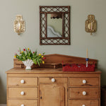 RETRO-RATTAN-MIRROR-TEAK-ON-A-WALL