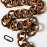 Brown metal chain with a carabiner on a white background