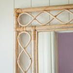 Retro-rattan-mirror-on-a-white-wall-close-up-top