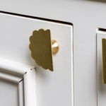 Scallop-knobs-Lacquered-brass-on-a-cabonet