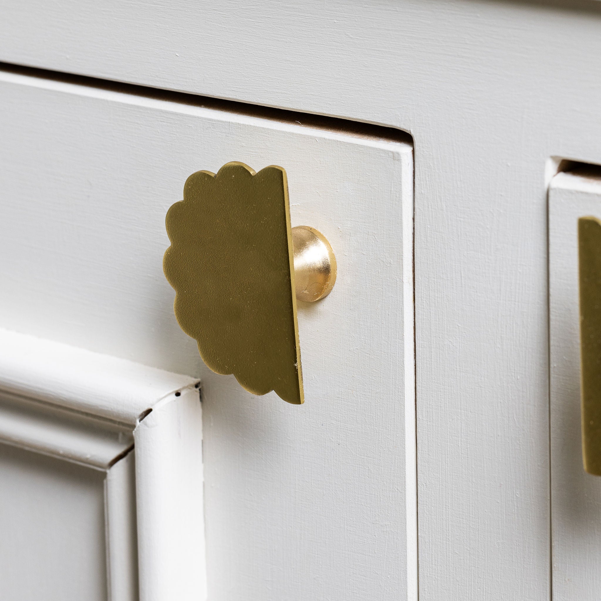Scallop-knobs-Lacquered-brass-on-a-cabonet