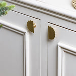 Scallop-knobs-Lacquered-brass-on-a-cabonet
