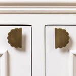 Scallop-knobs-antique-brass-on-a-cabinet