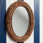 Serena-oval-mirror-teak-on-a-wall