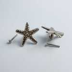 Starfish-shaped dresser knobs on a light gray background