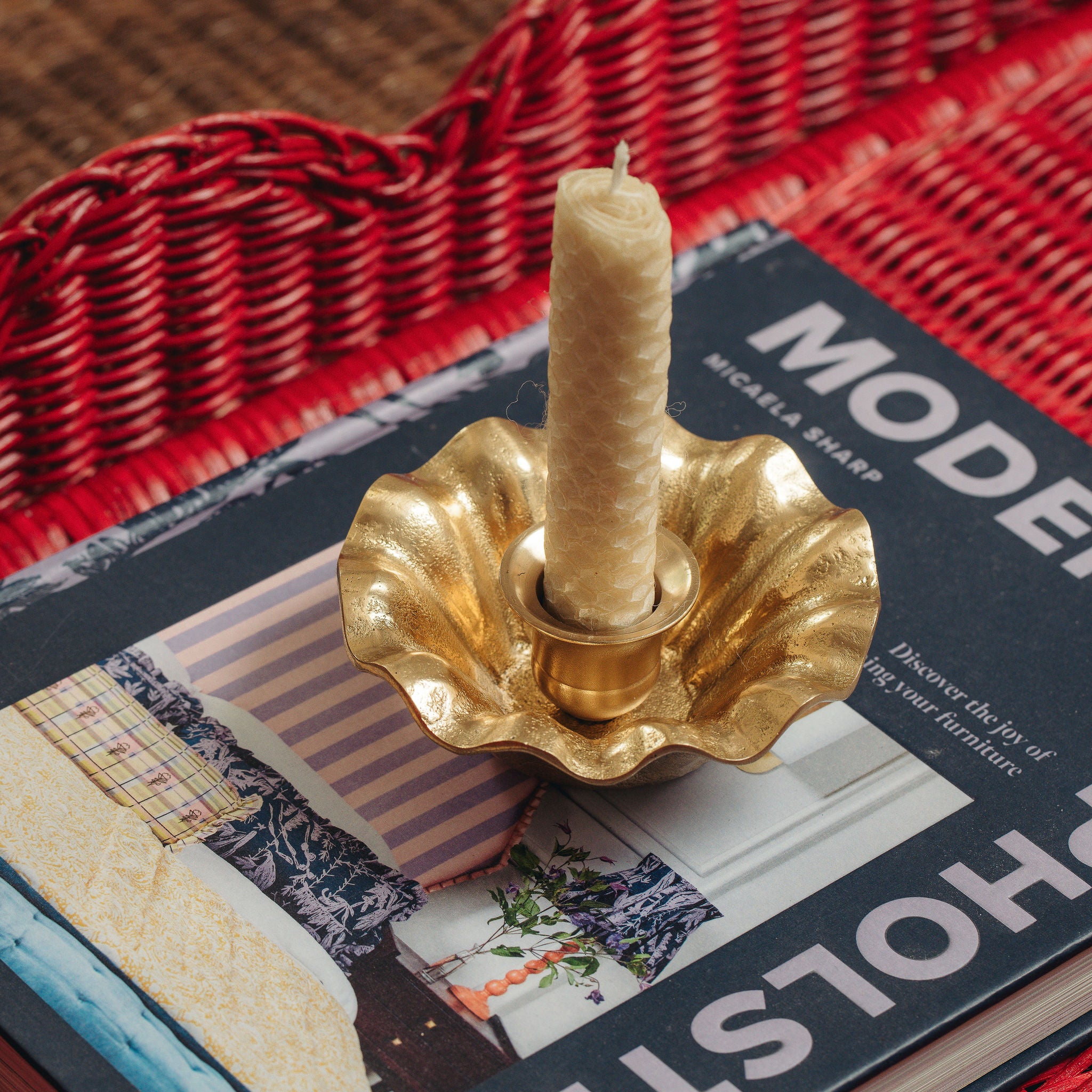 Wave candle holder with a candle on top of a magazine
